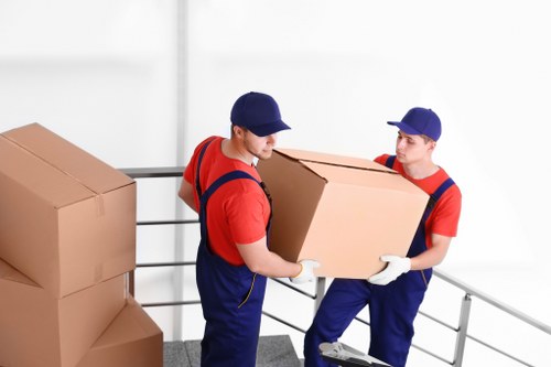Furniture removal team handling large household items in Colliers Wood