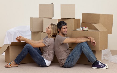 Local moving truck loading furniture and boxes near Colliers Wood