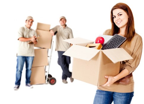 Furniture and boxes being loaded into a van for transport in Colliers Wood